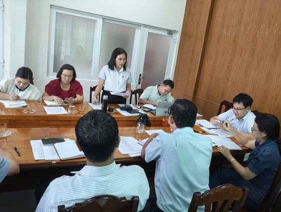 ''A group of people sitting around a table

Description automatically generated''