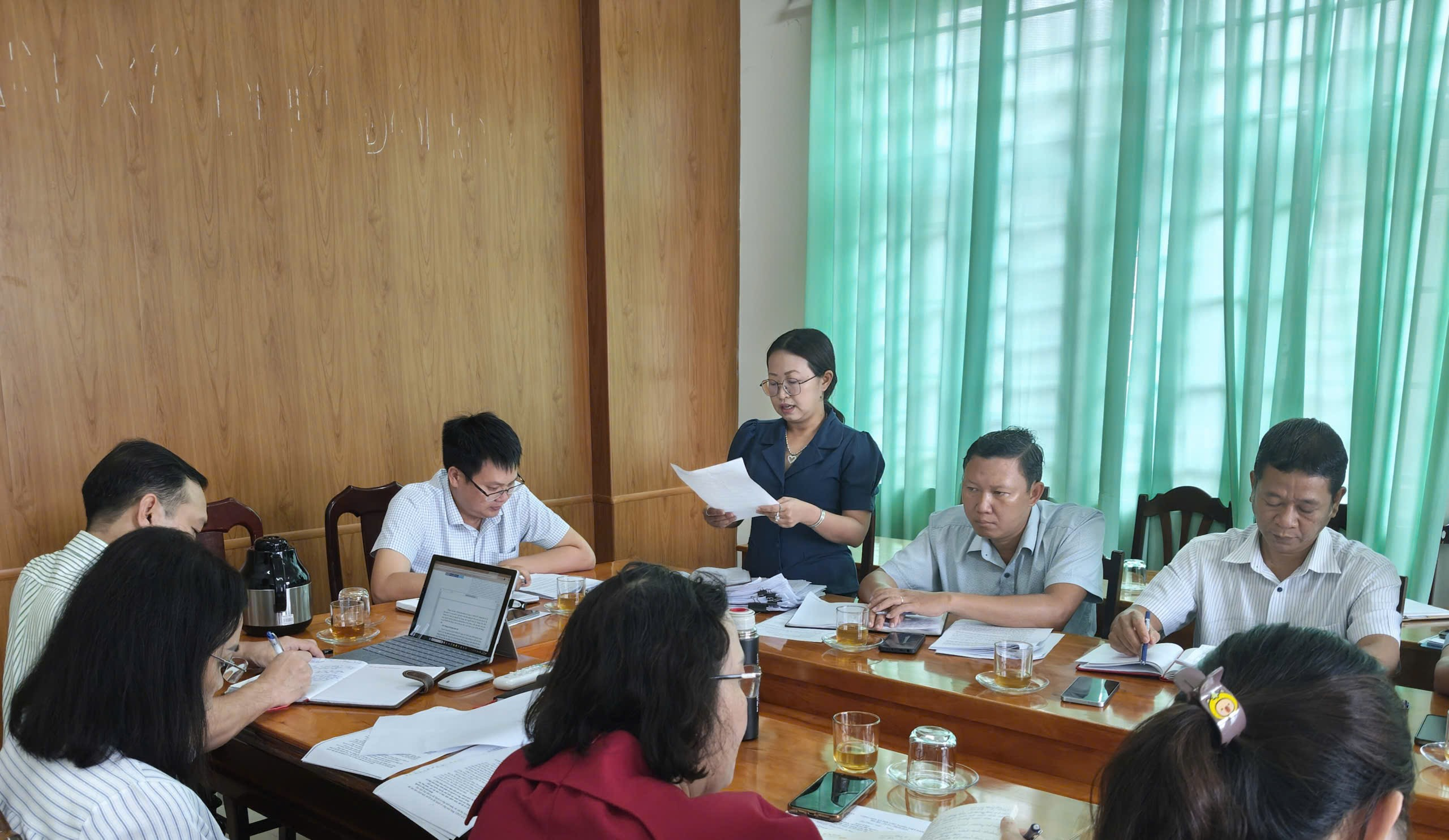 'A group of people sitting around a table

Description automatically generated'