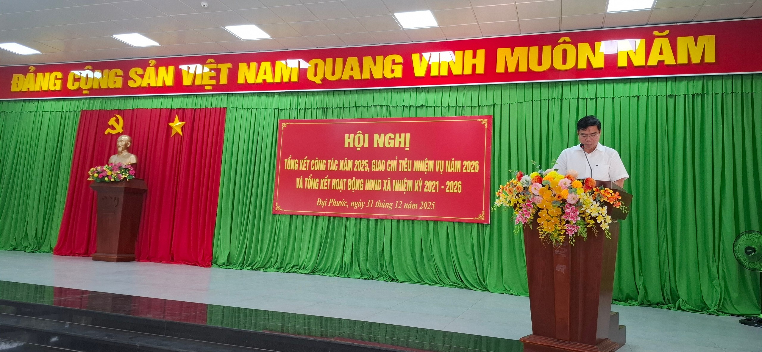 'A red sign on a stage

Description automatically generated'