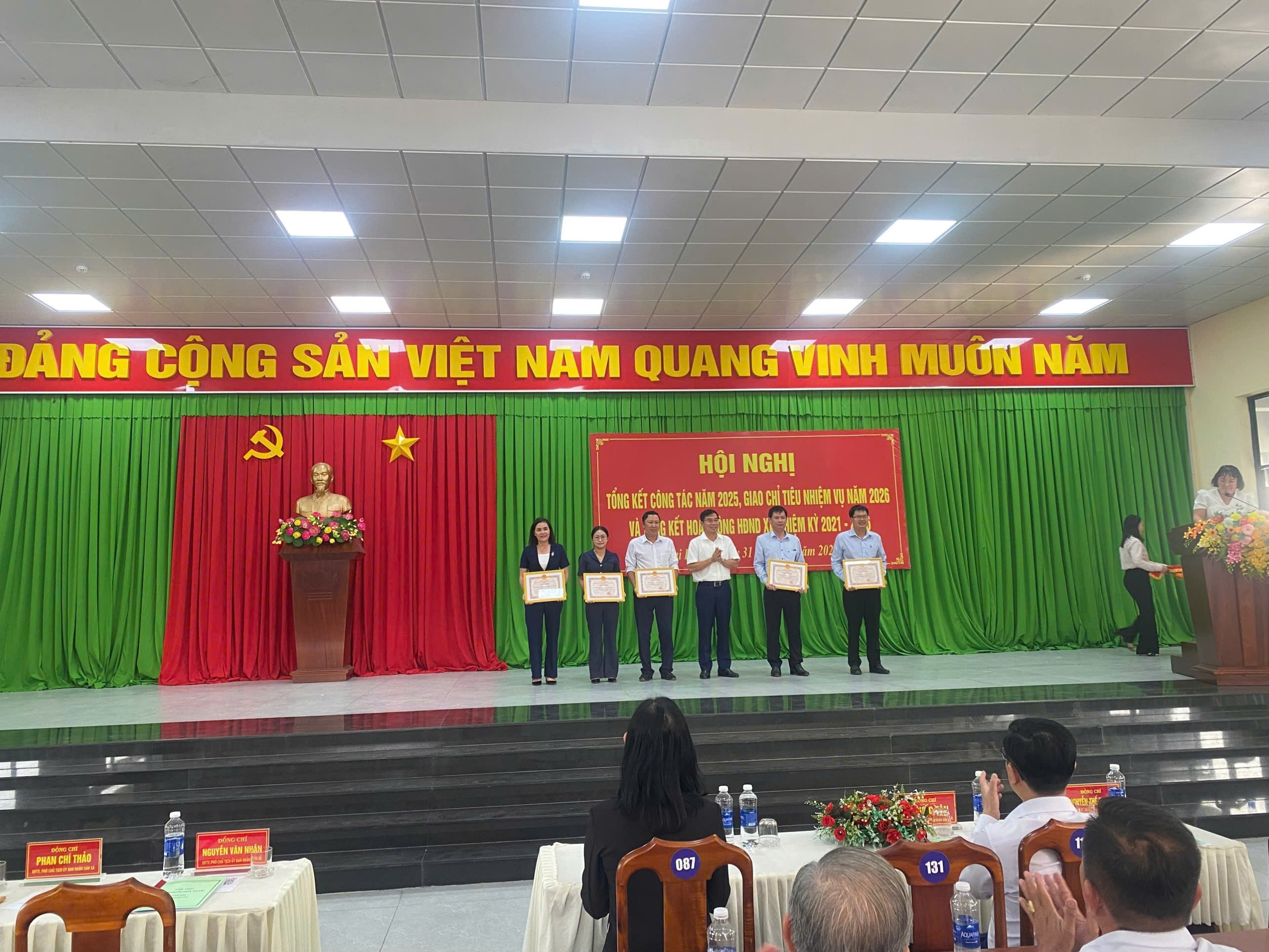 'A group of people on a stage

Description automatically generated'